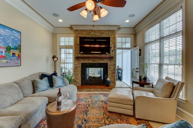Remodeled Family Room with abstract area rug and curved sectional