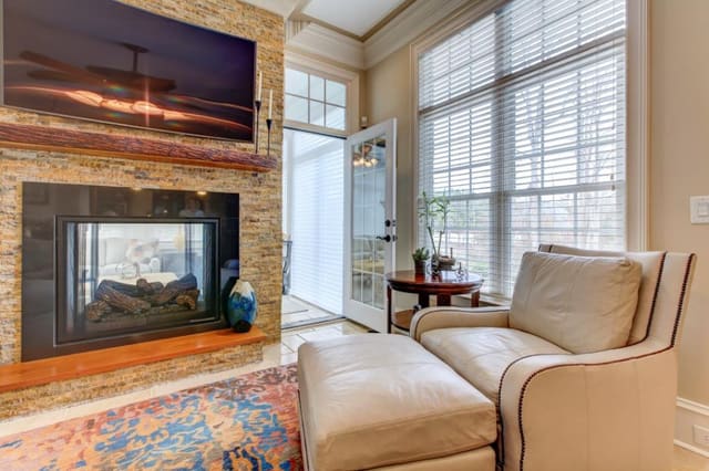 Remodeled Family Room with abstract area rug and leather chair and ottoman