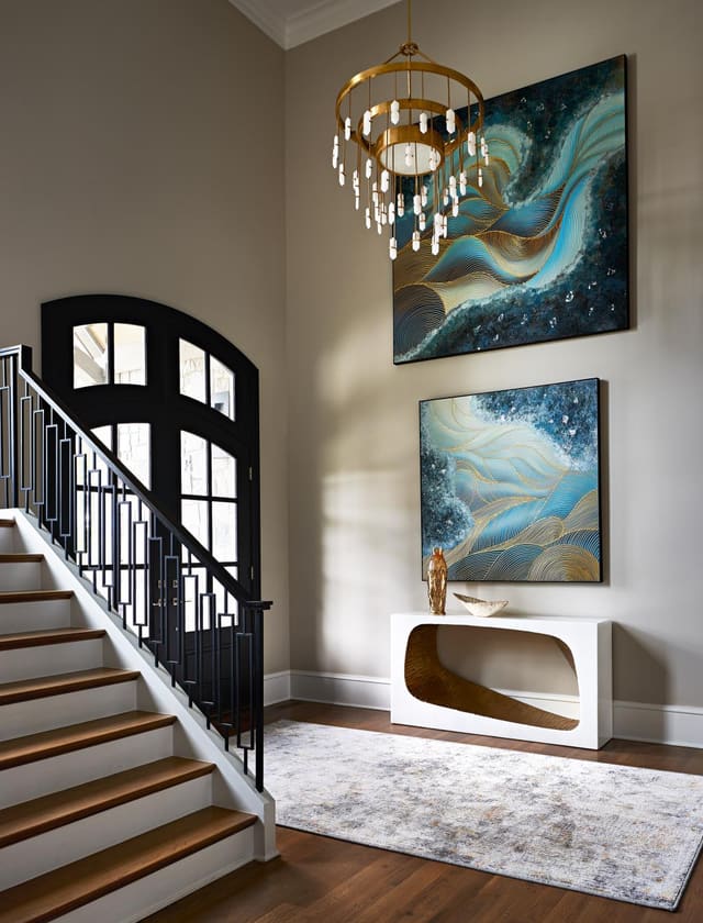 Foyer of Wake Forest Home with Two-Story ceilings, large chandelier and oversized artwork
