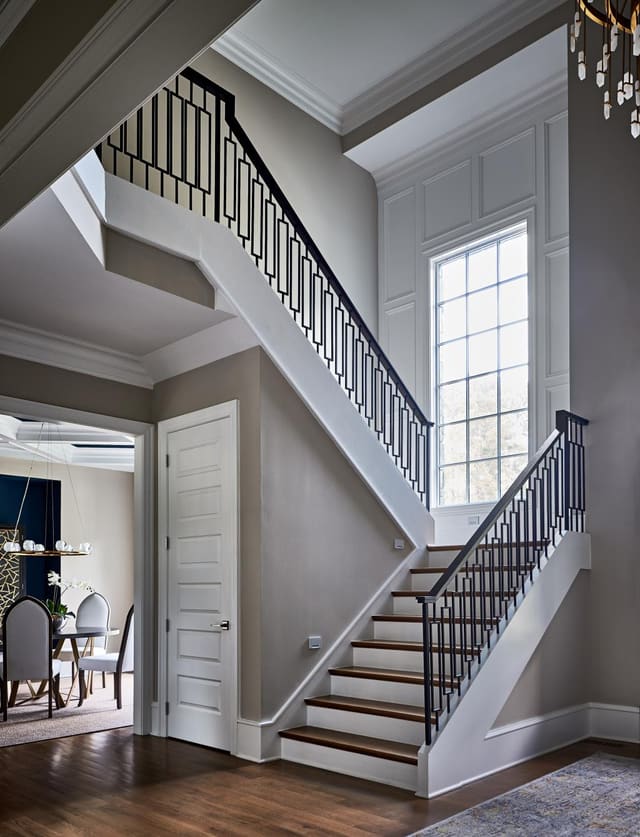 Foyer of Wake Forest home featuring staircase and large windo