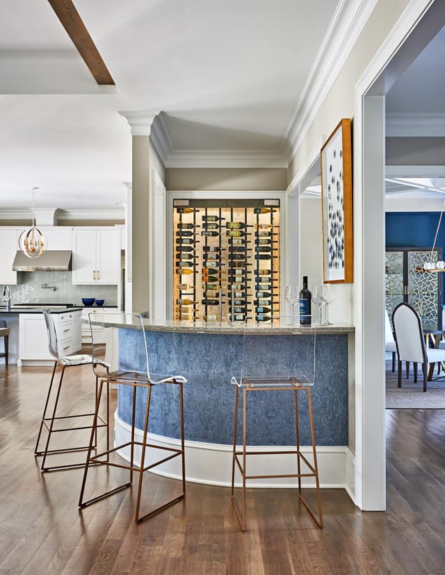 Wine Bar off of Kitchen in Wake Forest home, featuring lucite barstools