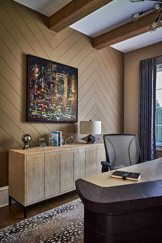 Study of Wake Forest Home featuring animal print rug, ivory shagreen console, chevron patterned walls, and abstract artwork