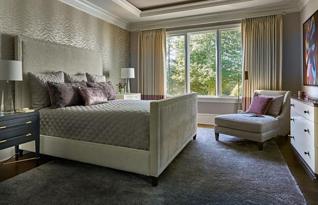 Master Bedroom in Wake Forest home featuring upholstered bed, custom window treatment with purple band, and animal print wallpaper accent wall
