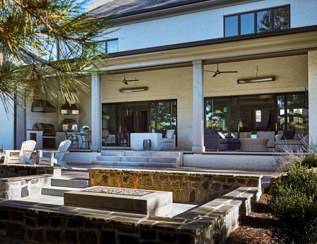Rear exterior of Wake Forest home with firepit, covered porch and outdoor Kitchen