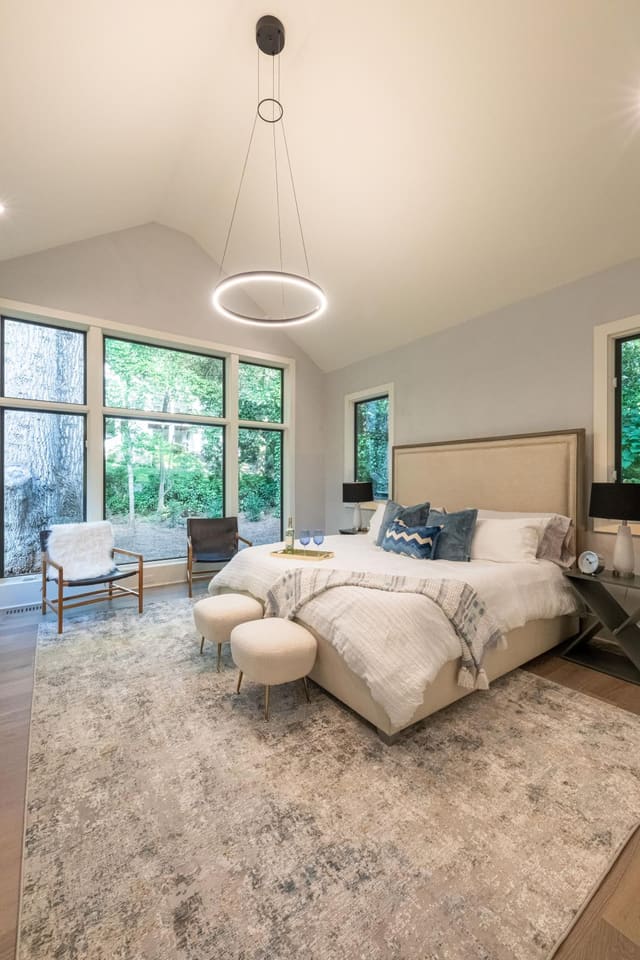 Primary bedroom with a contemporary light fixture above the bed.