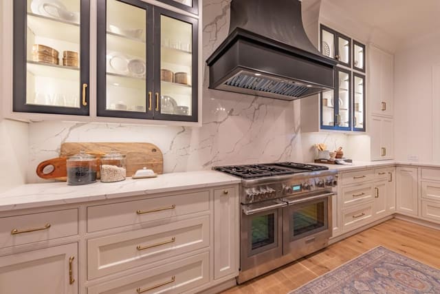 Kitchen of Raleigh home featuring black lantern pendants with contrast black cabinet fronts