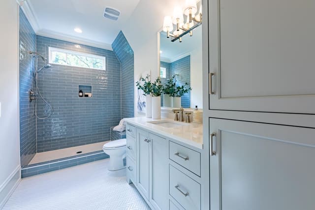 Raleigh Guest Bathroom with gray cabinets and blue tile