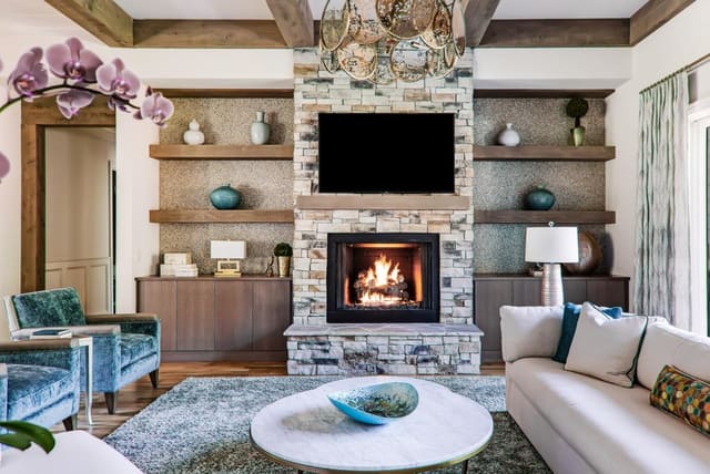 Cozy Family Room with floating shelves flanking stone fireplace.