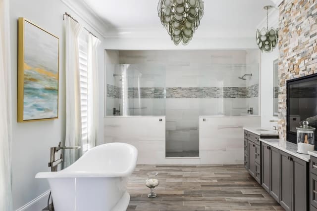 This unique chandelier is the perfect complement to the soothing tones of this Master Bathroom.