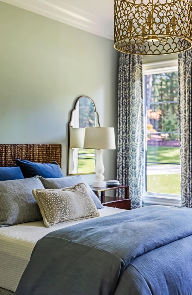 Custom lighting, bedding and drapery added a punch to this bedroom.