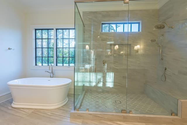 Stand alone tub with walk in grey marble shower