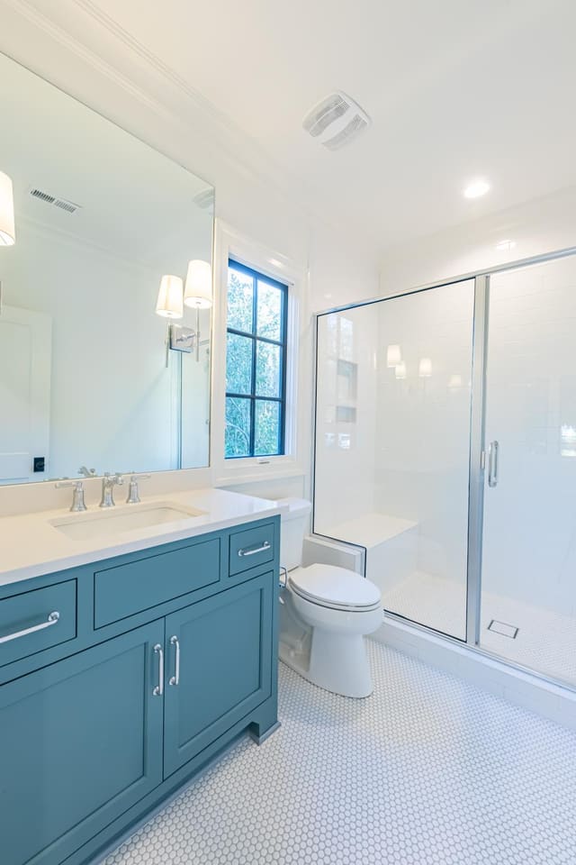 Bath with teal cabinets