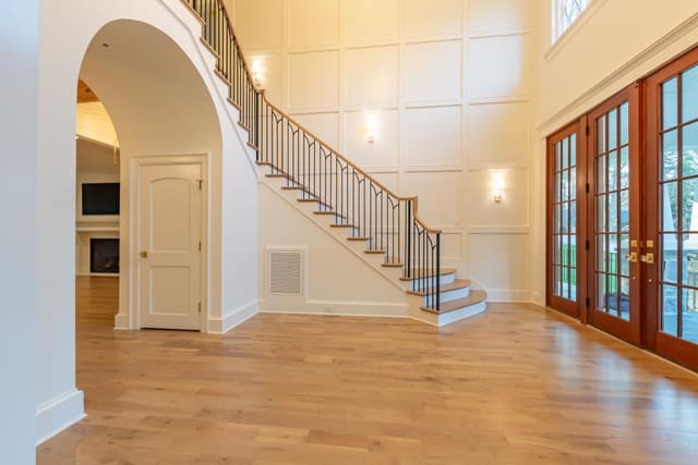 Inside Foyer with Warm Lighting on Accent Wall