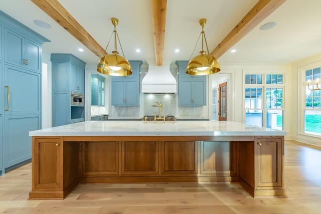 Kitchen with blue cabinetry and gold accents.