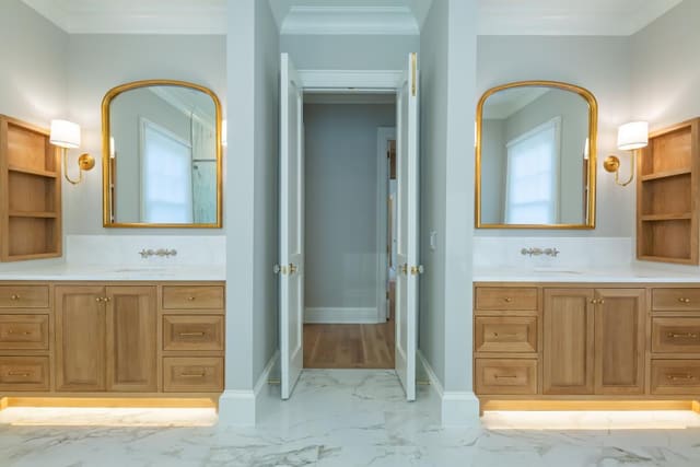 His and Hers bath with warm wood and gold accents.