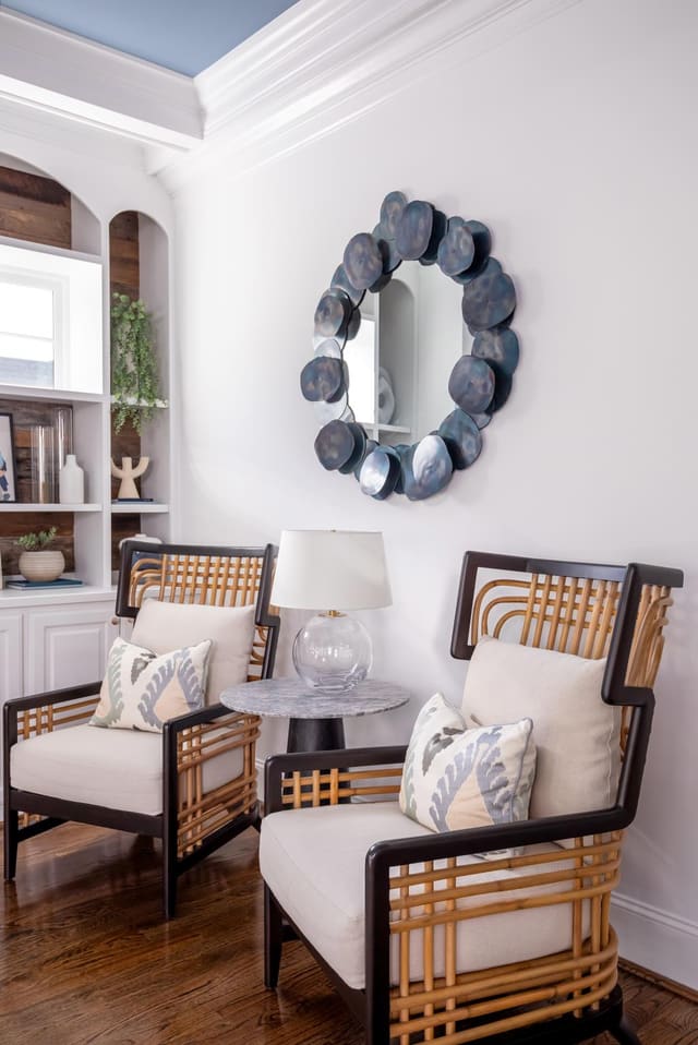 Sitting Area with abstract blue toned mirror and modern chairs