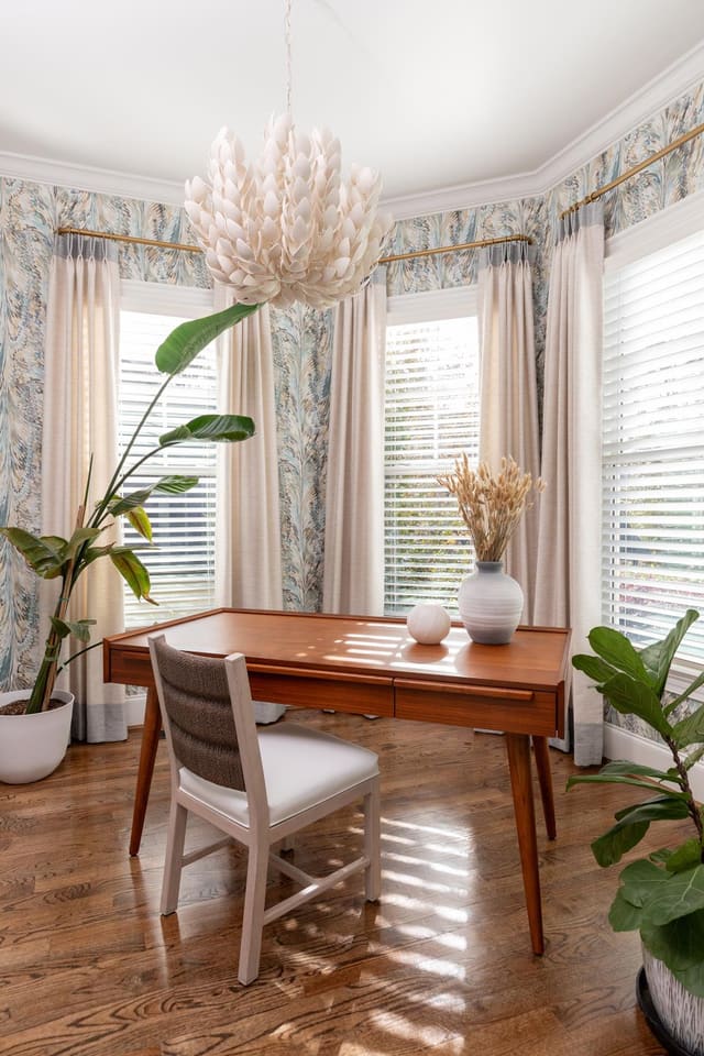 Study with blue toned wallpaper and white abstract light fixture