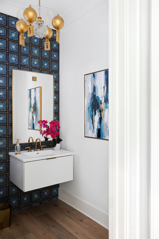 Powder bath with Louis Gaskill chandelier and blue tile wall covering.