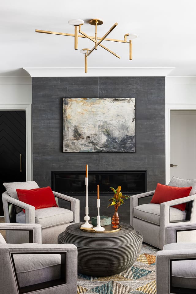 Basement area with four swivel chairs and an ottoman.