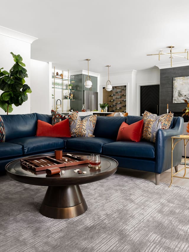 Basement area with leather sectional and cocktail table.