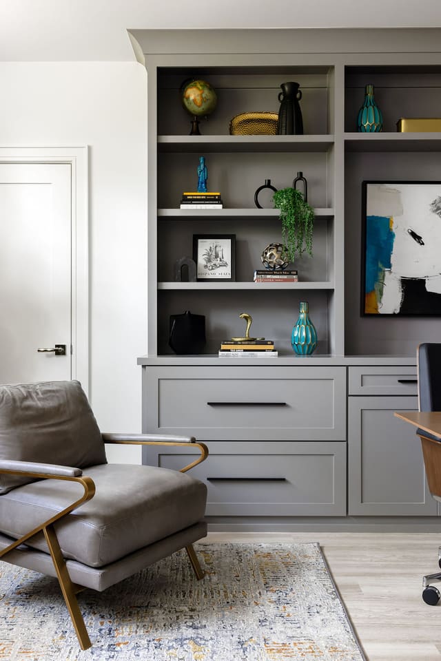Decorated built-in bookshelves in study.