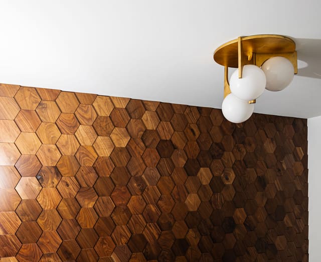 Wall covered with wooden tile.