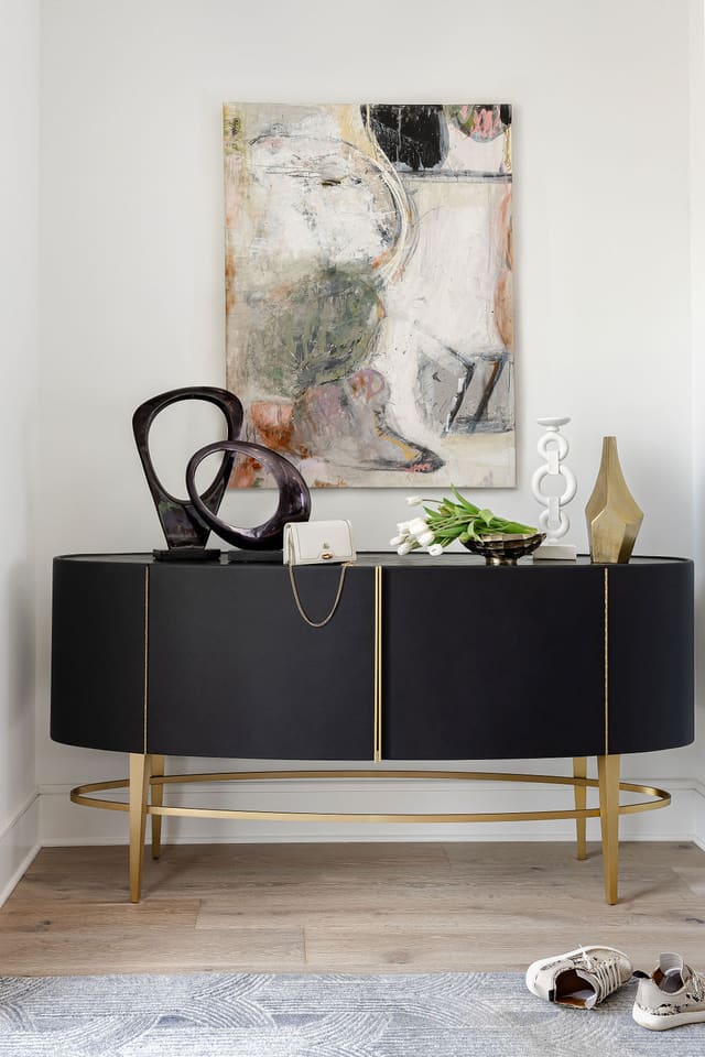 Entryway with beautiful console and Jenny Fassino art.