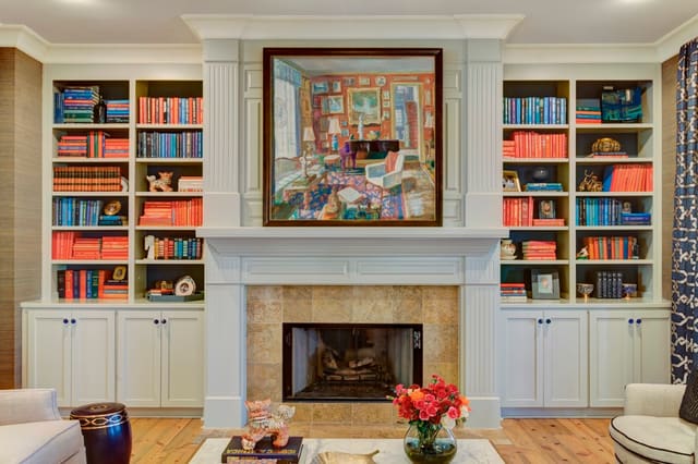 Living Room Fireplace with custom artwork and color coordinated books on built-ins