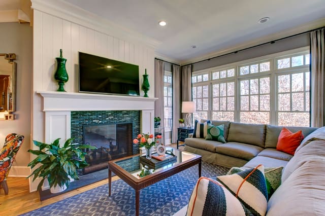 Hearth Room with tile fireplace surround, sectional, and custom window treatments