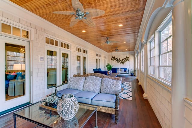 Enclosed Porch with stained ceilings and outdoor furniture