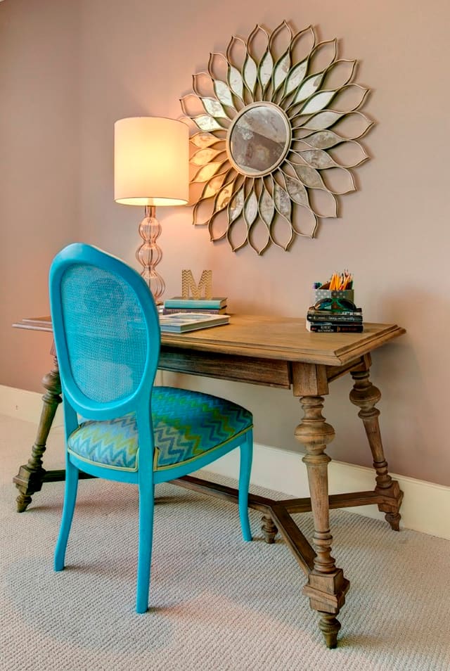 Girls bedroom with blue desk chair and sunburst mirror