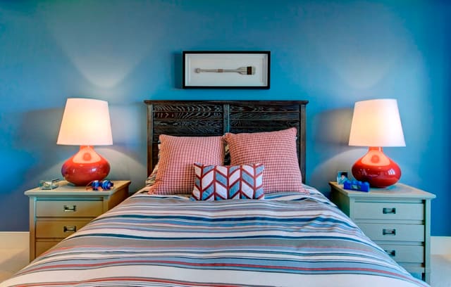 Boy's Bedroom with blue walls, red lamps, and semi custom bedding