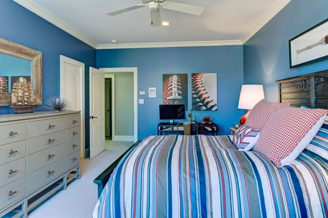 Boy's Bedroom with blue walls, red lamps, and semi custom bedding