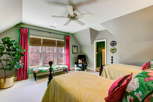 Guest Bedroom in yellow pink and green, with pink drapery panels, 2 twin beds, and chiang mai fabric bench