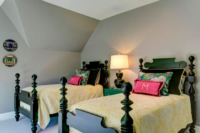 Guest Bedroom in yellow pink and green, with pink drapery panels, black twin beds, and custom bedding