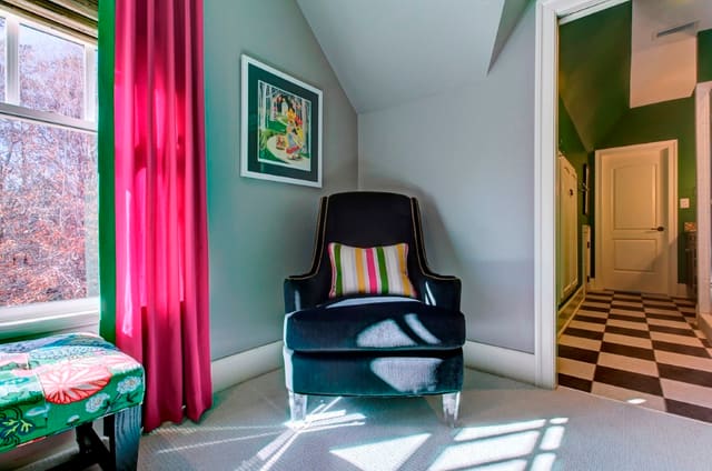 Guest Bedroom with pink drapery panels, chiang mai fabric bench, and black velvet chairs with lucite legs