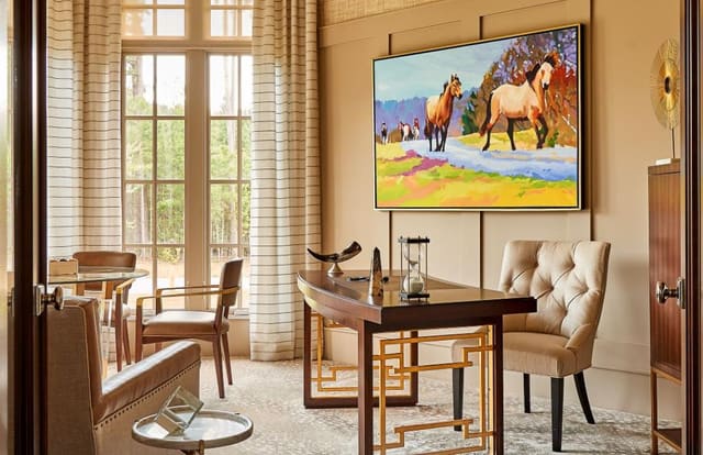 Study in neutral tones with vibrant original artwork.  Featuring sheer window treatments, grasscloth wallpaper, and furniture with gold accents.