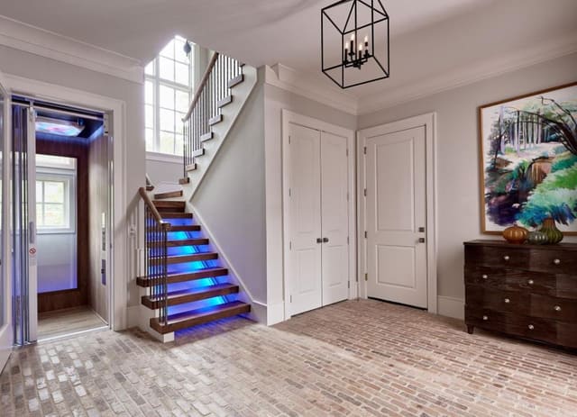 Mud Room showing entrance to elevator and back stairway featuring LED lighting.