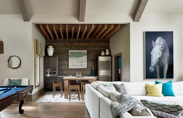 Game Room featuring panelled accent wall and large scale artwork.