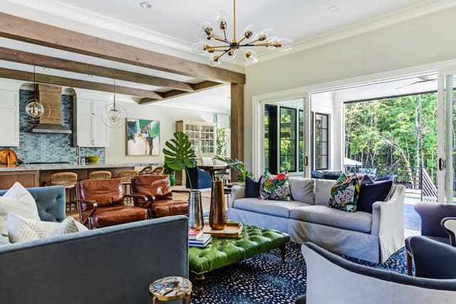 Close up of N. Raleigh Family Room showing green leather ottoman and navy antelope area rug