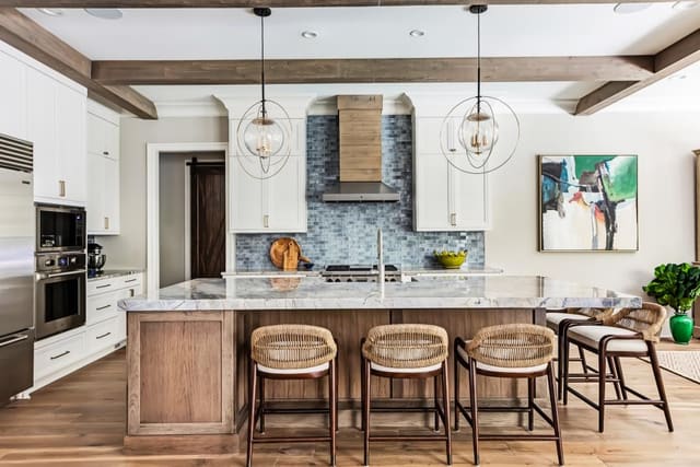 N. Raleigh Kitchen with contrasting island, metal and wood custom hood, clear pendant lighting, and low back counter stools