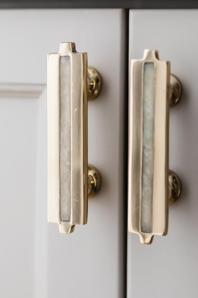 Close up of cabinet with decorative pearl and brass handles