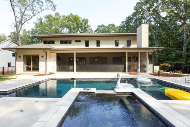 View of back of Avalaire home with pool and hot tub