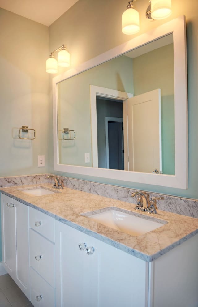 Guest Bathroom in North Raleigh home with marble countertops, white cabinets, and crystal knobs.