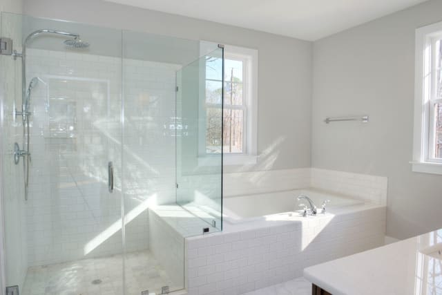 Master Bathroom with white tile in shower and tub surround and white quartz countertop