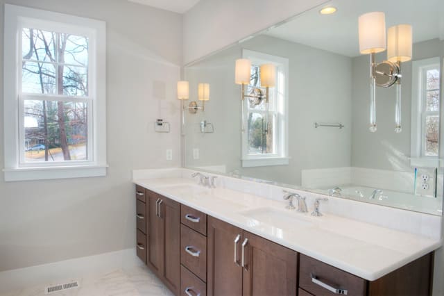 Master Bathroom with dark wood vanity and white quartz countertops