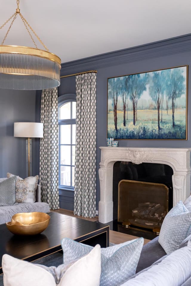 Fireplace with art hanging above.