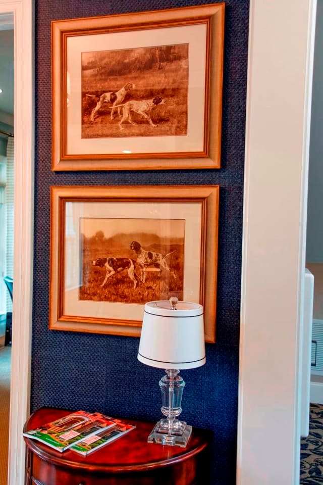 Closeup of blue grasscloth wallpaper and dog prints