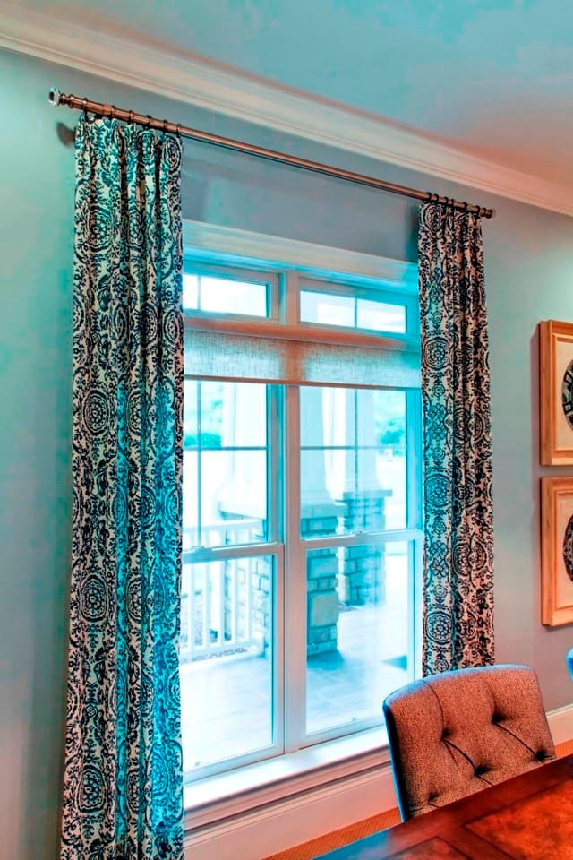 Conference Room navy and ivory damask drapery panels with antique silver hardware over roller shade