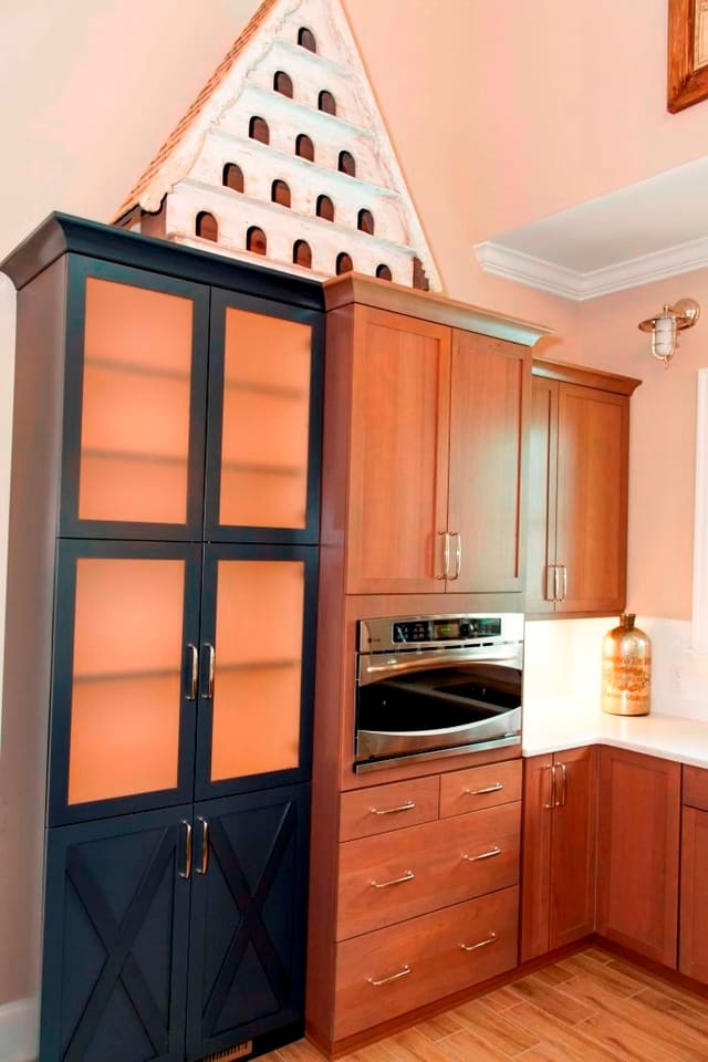 Kitchen in Raleigh clubhouse with contrasting cabinets and large accessory